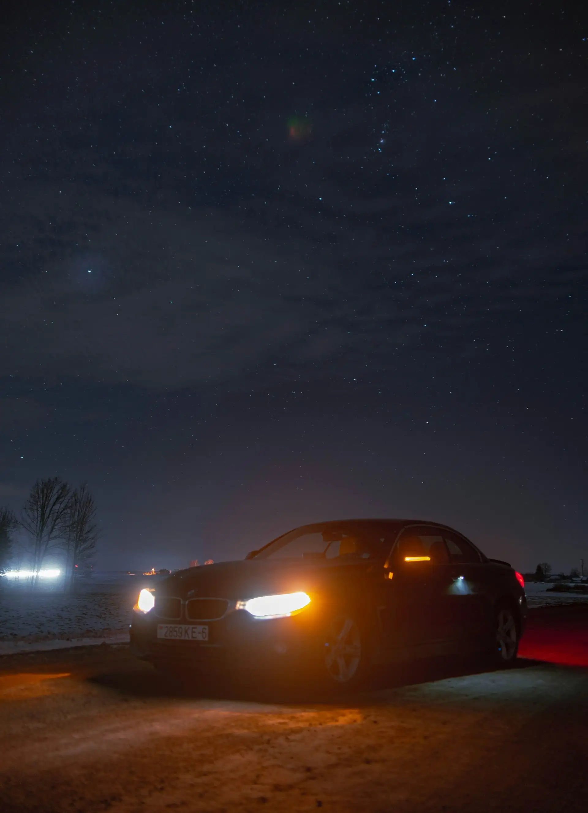 Black car in the road at night